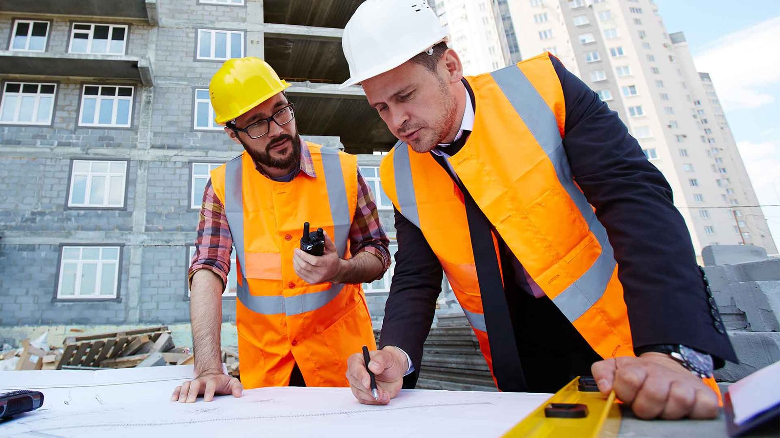 Contractors reviewing plans on a job site